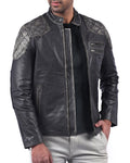 Men’s black leather jacket with skull and crossbones design and front zip closure

